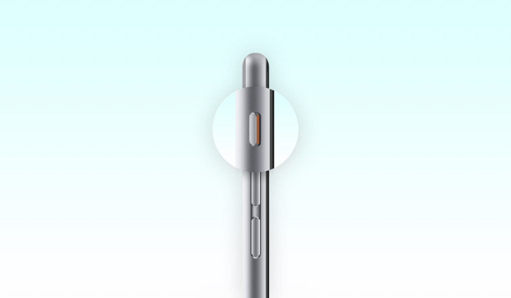 iPhone mit vergrößerter Stummschalttaste auf weißem Hintergrund