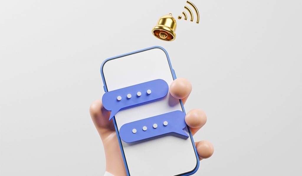 a cartoon-style graphic showing a hand holding a smartphone. there are two chat clouds on the smartphone screen. Above the top-right corner of the smartphone, there's a bell with a WiFi symbol over it