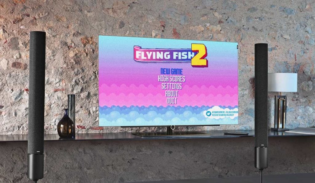 Flying Fish 2 game main menu on a TV screen. the TV stands on a glass shelf, by a wall made out of a combination of large stones and concrete. There are two vertical soundbars on the sides of the TV. The shelf has two intricate vases and a lamp on it