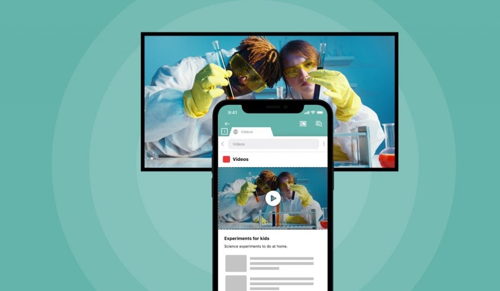 an iPhone mirroring a video titled 'experiments for kids' that shows two people in science kilts, googles and protective gloves holding two test tubes in a lab