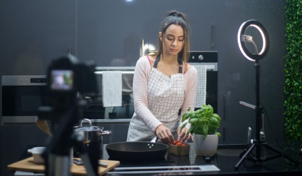 woman cooking in front of a camera