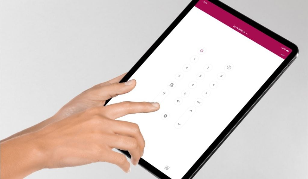 a hand using an iPad with the LG TV remote app on the screen