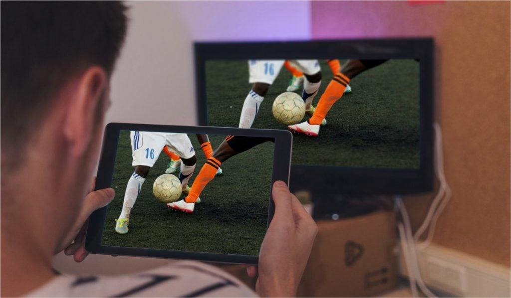 A man casting a football match from Android tablet to Sony TV.