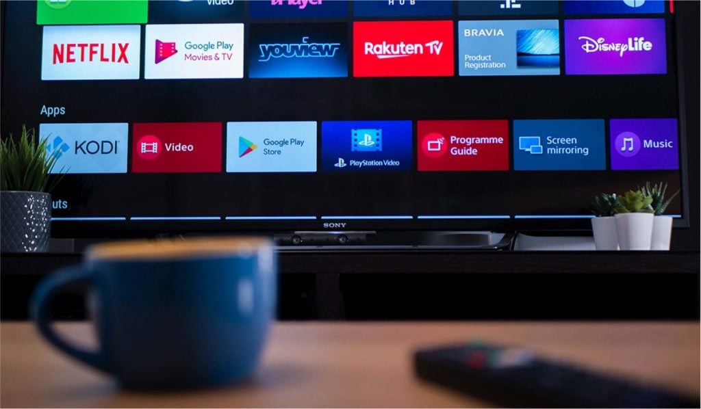 App icons on a Sony TV, a mug and a remote control