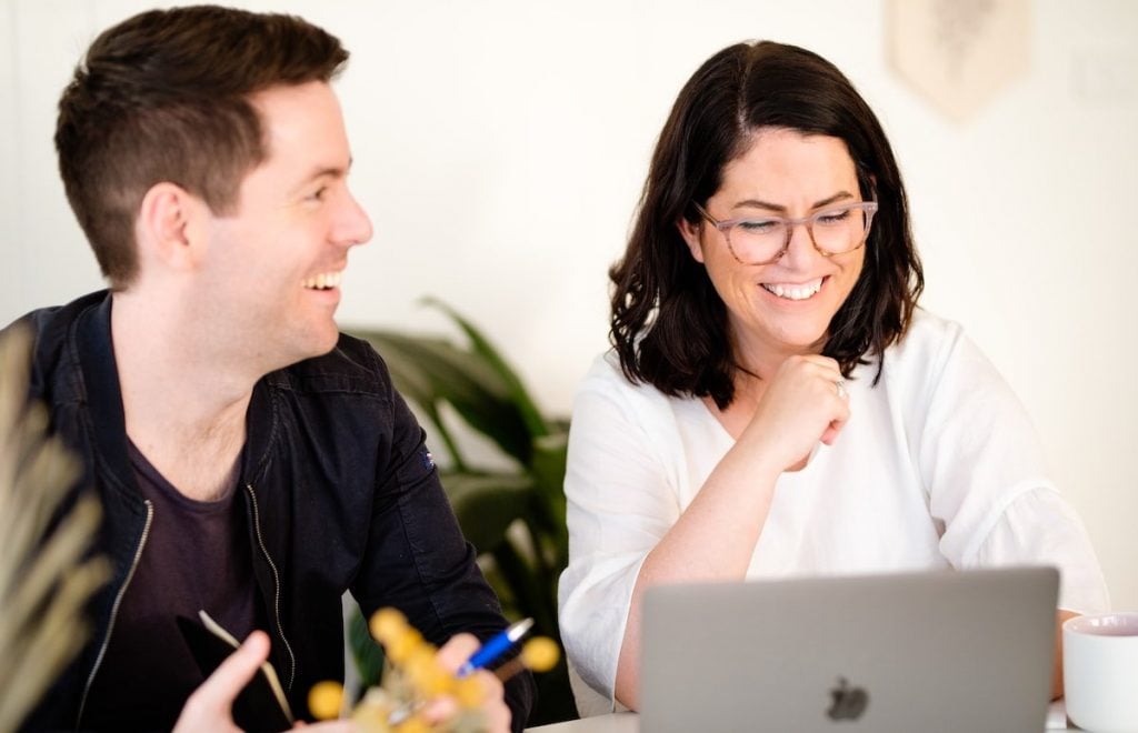 two employees working together while having some fun