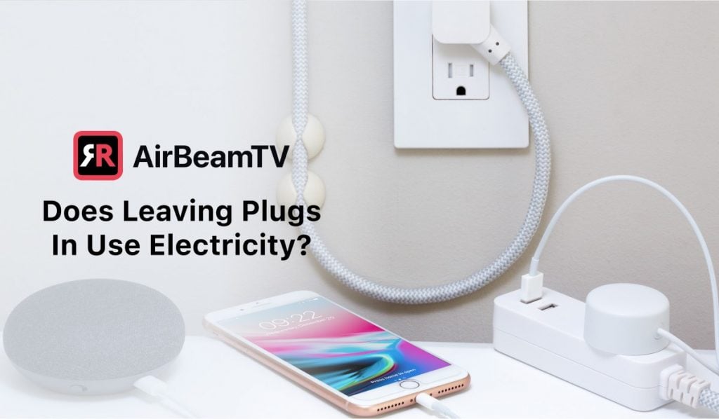 A featured image with the header 'Does Leaving Plugs In Use Electricity?', an AirBeamTV logo and an image of an iPhone being charged. The charger is plugged to an extension cord and there's another cable plugged into a wall outlet