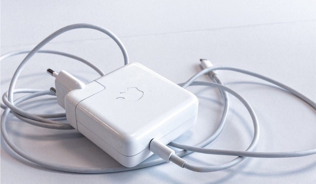 A MacBook charger and a USB-C cable on white surface