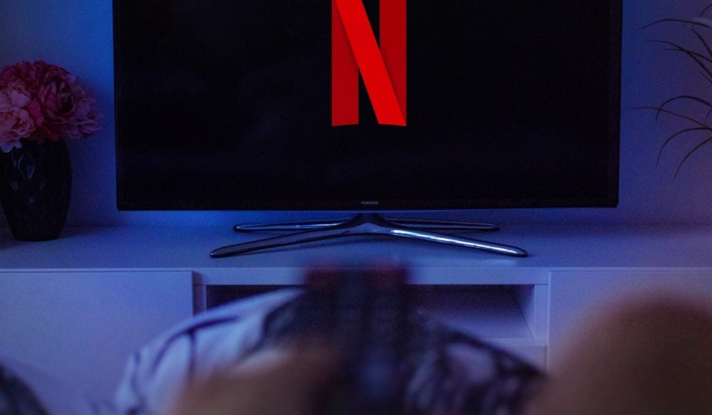 Netflix logo on TV. The TV is in a dimly lit room.