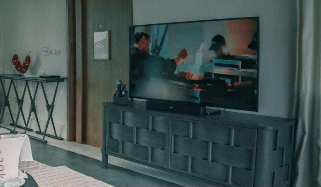 A TV on a drawer in a living room.