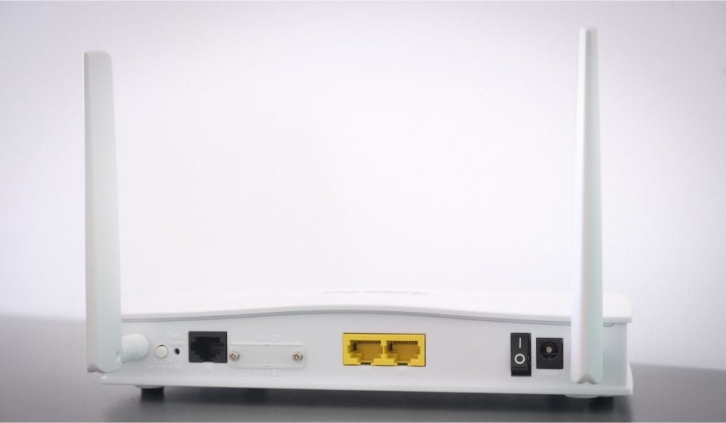 A white router with two antennas.
