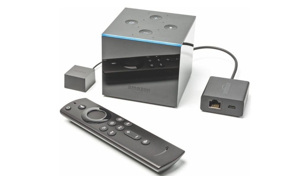 Fire tV cube device with an adapter and a remote