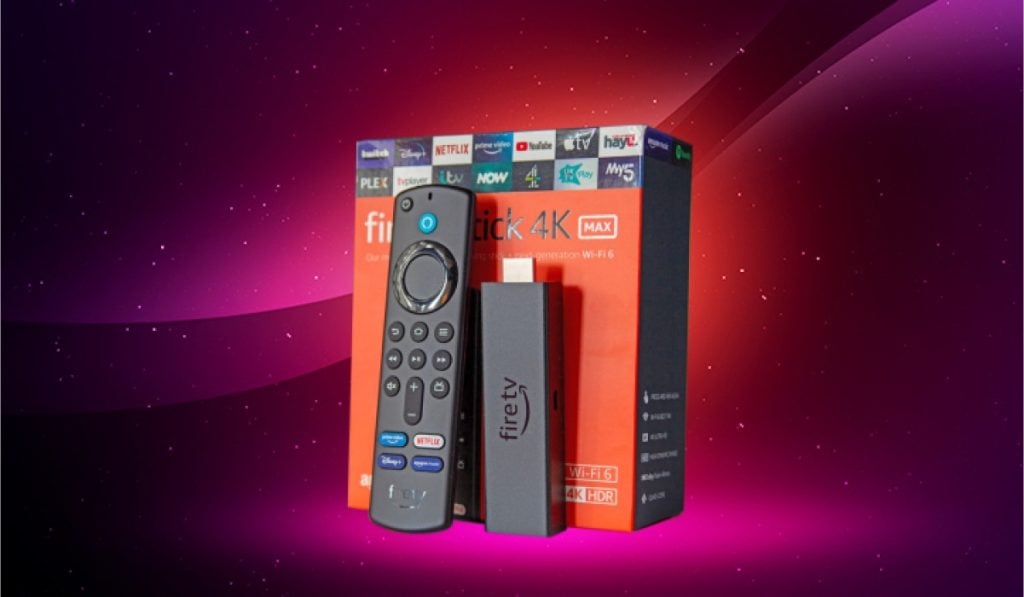 A Fire TV remote and a Firestick propped up against a Fire TV box