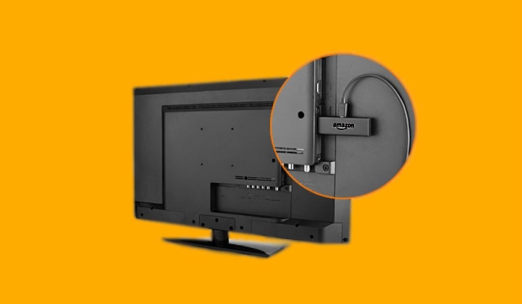 A closeup of a Firestick plugged into a TV