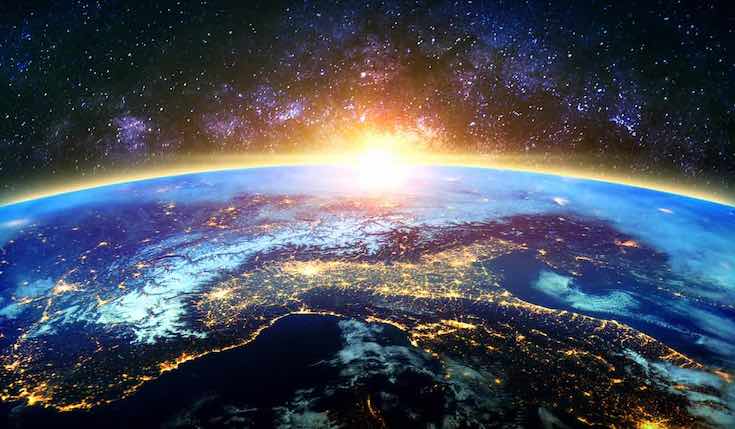 earth as seen from space with sun in the distance