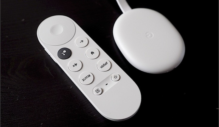 White Chromecast remote and white Chromecast device on black background