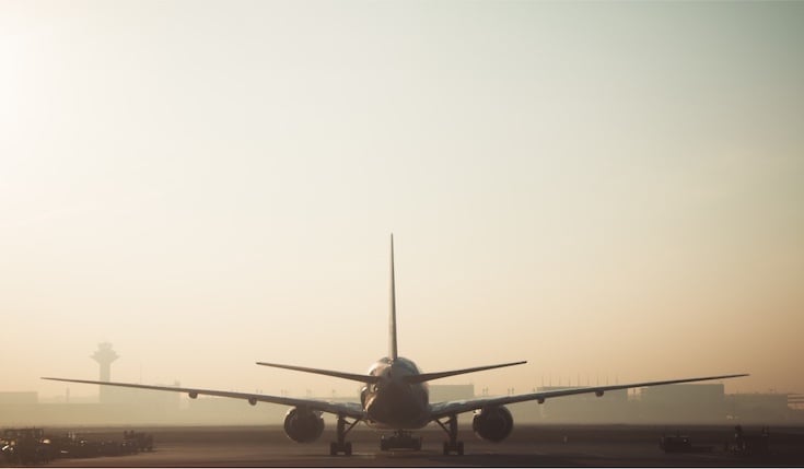 plane landing on an airport on a hot day