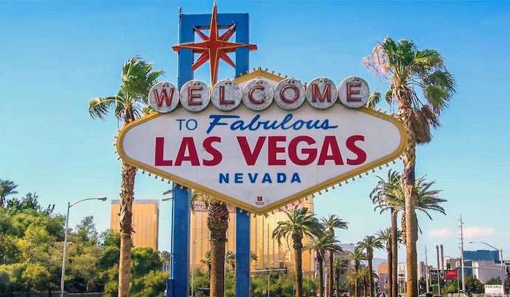 welcome to fabulous Las Vegas Nevada sign with palm trees and buildings in the background