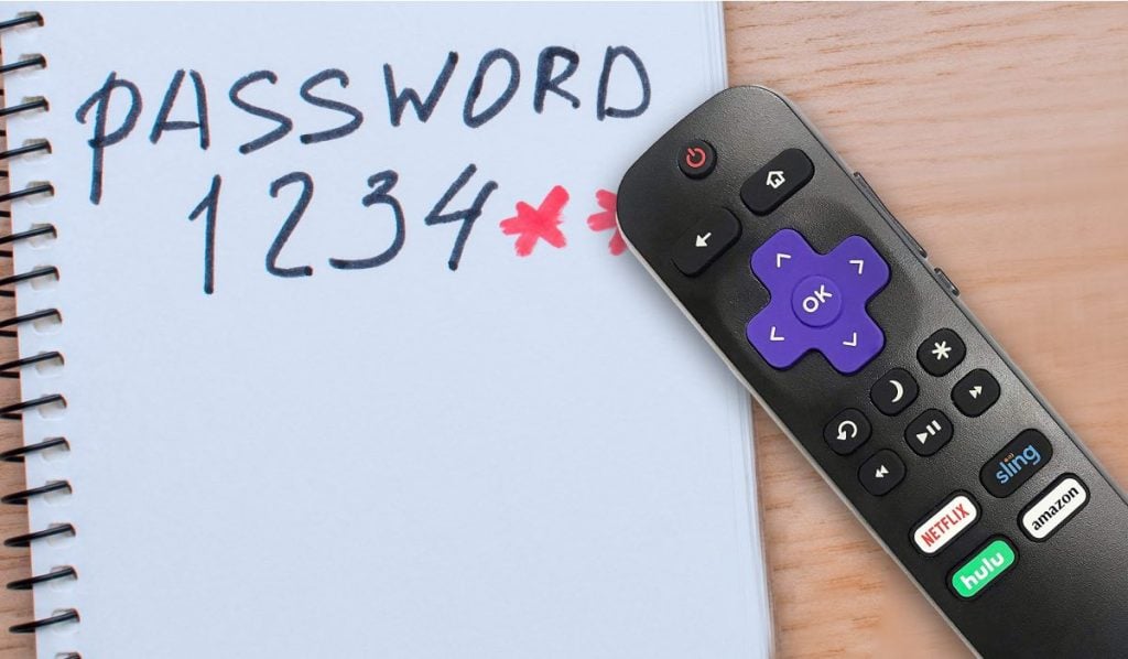 A Roku remote and a card with "Password 1234*" written on it