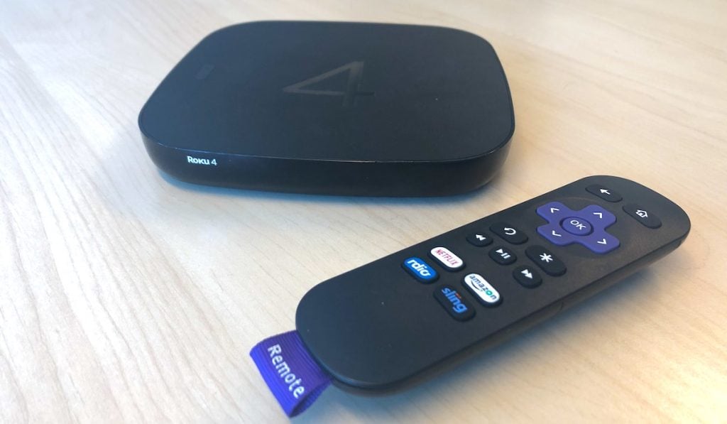 roku device and a remote on wooden surface