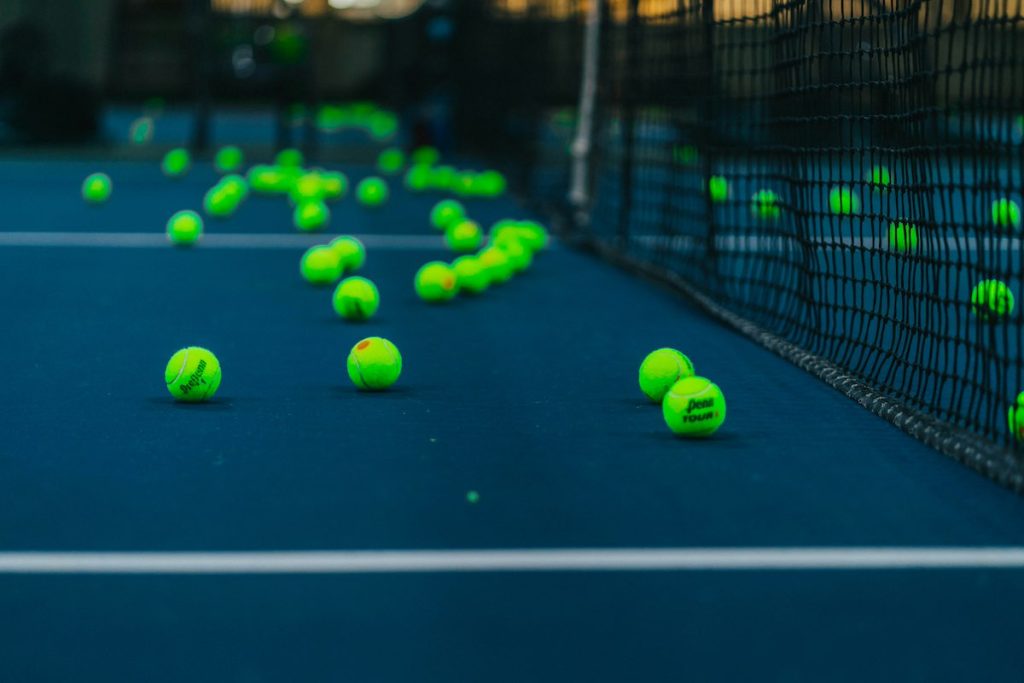 multiple tennis balls on tennis court